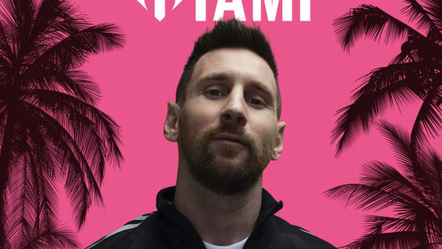 Lionel Messi poses in black adidas apparel.